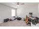 Inviting bedroom with neutral paint, ceiling fan, and a window providing ample natural light at 494 Amadoras Way, St Cloud, FL 34771