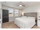 Inviting bedroom features two windows for natural light, a dark-colored door, and a comfortable gray headboard at 494 Amadoras Way, St Cloud, FL 34771