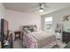Cozy bedroom features a ceiling fan, and neutral wall color that creates a soothing atmosphere at 494 Amadoras Way, St Cloud, FL 34771