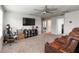 Spacious bonus room with plush carpeting, ceiling fan, and media center perfect for entertaining or relaxing at 494 Amadoras Way, St Cloud, FL 34771