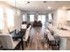 Open concept dining area with a dark wood table and light beige chairs at 494 Amadoras Way, St Cloud, FL 34771