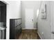 Bright entryway with wood-look flooring, white door, and shoe storage at 494 Amadoras Way, St Cloud, FL 34771