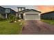 Charming two-story home featuring a brick driveway and attached two-car garage with a well manicured lawn at 494 Amadoras Way, St Cloud, FL 34771