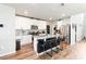 Well-lit kitchen featuring stainless steel appliances, granite counters, and a black kitchen island with seating at 494 Amadoras Way, St Cloud, FL 34771