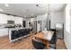 Open concept kitchen and dining area, with black island seating, stainless steel appliances, and modern finishes at 494 Amadoras Way, St Cloud, FL 34771