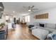 Spacious open-concept living area with a sofa, dining table, kitchen, and a ceiling fan at 494 Amadoras Way, St Cloud, FL 34771