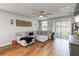 Inviting living room with a sectional sofa, modern decor, and sliding glass doors leading to the backyard at 494 Amadoras Way, St Cloud, FL 34771