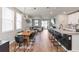 Open concept living and dining room with dark wood floors and an open kitchen featuring a bar at 494 Amadoras Way, St Cloud, FL 34771