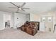 Comfortable loft space featuring a recliner, a ceiling fan, and natural light from the windows at 494 Amadoras Way, St Cloud, FL 34771