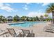 Community pool surrounded by lounge chairs and palm trees, offering a resort-like experience for residents at 494 Amadoras Way, St Cloud, FL 34771