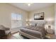 Bright bedroom with large window, comfortable bed, and seating area at 5961 Westgate Dr # 2034, Orlando, FL 32835
