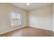 Clean bedroom with wood flooring, one large window, and a ceiling fan at 5961 Westgate Dr # 2034, Orlando, FL 32835