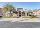 Community clubhouse with palm trees and brick pavement at 5961 Westgate Dr # 2034, Orlando, FL 32835