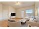 Living room with light walls, hardwood floors, and staged furniture at 5961 Westgate Dr # 2034, Orlando, FL 32835