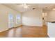 Cozy living room features wood flooring, a ceiling fan, and sliding glass door at 5961 Westgate Dr # 2034, Orlando, FL 32835