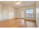 Bright living room featuring wood flooring, a ceiling fan, and a sliding glass door at 5961 Westgate Dr # 2034, Orlando, FL 32835