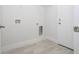 Bright laundry room with vinyl flooring and shelving at 6 Malauka Pass, Ocklawaha, FL 32179