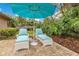 Brick patio with white lounge chairs and teal umbrella at 615 Tuskawilla Point Ln, Winter Springs, FL 32708