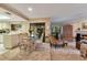 Bright dining area with a glass-top table and chairs, adjacent to living room at 615 Tuskawilla Point Ln, Winter Springs, FL 32708