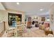 Charming dining area with whitewashed table and chairs near the living area at 615 Tuskawilla Point Ln, Winter Springs, FL 32708
