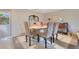 Formal dining room with glass-top table and seating for four at 615 Tuskawilla Point Ln, Winter Springs, FL 32708
