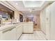 Open kitchen with island, stainless steel appliances, and view into living area at 615 Tuskawilla Point Ln, Winter Springs, FL 32708