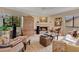 Cozy living room with a fireplace, comfortable seating, and large windows at 615 Tuskawilla Point Ln, Winter Springs, FL 32708