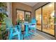 Relaxing patio with blue chairs and view of the dining room at 615 Tuskawilla Point Ln, Winter Springs, FL 32708
