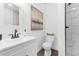 Bright bathroom featuring a white vanity, toilet, and tiled shower at 720 Jasmine Ave, Orange City, FL 32763