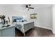 Bright bedroom featuring a ceiling fan, and a matching blue bed frame and dresser at 720 Jasmine Ave, Orange City, FL 32763