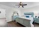 Bedroom featuring light colored wooden floors, an art piece, and an ensuite bathroom with closet space at 720 Jasmine Ave, Orange City, FL 32763