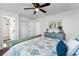Bedroom showcasing a ceiling fan, an ensuite bathroom with closet space, and light-filled interior at 720 Jasmine Ave, Orange City, FL 32763