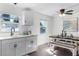 Dining area with white cabinets, modern lighting and windows at 720 Jasmine Ave, Orange City, FL 32763