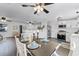 An open-concept space with dining area, kitchen, and living area under bright, stylish lighting at 720 Jasmine Ave, Orange City, FL 32763