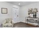 Bright foyer with wood-look floors, modern decor, and a stylish accent chair at 720 Jasmine Ave, Orange City, FL 32763