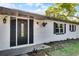 Close up of front exterior featuring a glass paneled door and decorative planters at 720 Jasmine Ave, Orange City, FL 32763