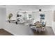 Bright kitchen with white cabinets, stainless steel appliances, and an adjacent dining area at 720 Jasmine Ave, Orange City, FL 32763
