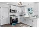 Clean, bright kitchen with white cabinets, appliances, and ample counter space at 720 Jasmine Ave, Orange City, FL 32763