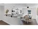 Bright kitchen with white cabinets, stainless steel appliances, breakfast bar, and adjacent dining area at 720 Jasmine Ave, Orange City, FL 32763