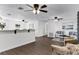 Open-concept living area with updated flooring, ceiling fans, and bright, neutral paint at 720 Jasmine Ave, Orange City, FL 32763