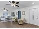 Bright living room featuring hard surface floors, a ceiling fan, and a decorative bookshelf at 720 Jasmine Ave, Orange City, FL 32763