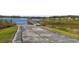 Boat ramp leading to a lake with a pier and gazebo at 734 Rainfall Dr, Winter Garden, FL 34787