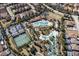 Aerial view of community with pool, tennis courts, and homes at 7530 Oak Spring Ln, Davenport, FL 33837