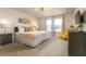 Main bedroom with king-size bed, yellow chair, and large windows at 7530 Oak Spring Ln, Davenport, FL 33837