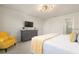 Bright bedroom with yellow armchair and large bed at 7530 Oak Spring Ln, Davenport, FL 33837
