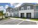 Two-story townhome with gray siding and teal accents at 7530 Oak Spring Ln, Davenport, FL 33837