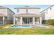 Home's back features a pool, patio, and grill at 7783 Westland Dr, Kissimmee, FL 34747