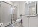 Clean bathroom with a walk-in shower, granite vanity, and white cabinets at 7783 Westland Dr, Kissimmee, FL 34747