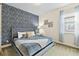 Bedroom with king-size bed and tree-patterned wall at 7783 Westland Dr, Kissimmee, FL 34747