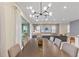Spacious dining area with modern chandelier and backyard view at 7783 Westland Dr, Kissimmee, FL 34747